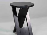 the table is made of wood and has a black top