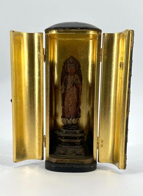a small gold clock with a statue inside of it