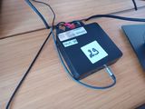 a laptop and a mouse on a table with a price tag