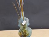 a glass vase that has a bunch of flowers in it