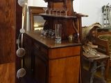 a wooden cabinet with a clock on top of it in a room