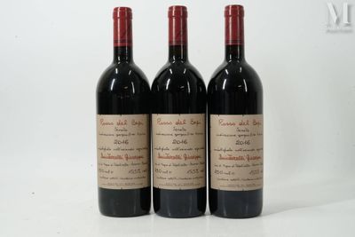 three bottles of red wine sitting next to each other on a white surface