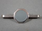 a silver tie bar with a mirror on it