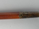 an old pipe with a wooden handle on a white surface