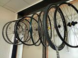 many bikes hanging on the wall in the room