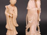 three carved ivory figurines of a woman and a man