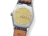 a close up of a watch on a white surface