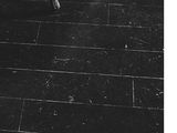 a black and white photo of a woman walking in the rain