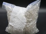 a bag of shredded white rice sitting on a black surface