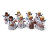 seven figurines of angels sitting on top of each other