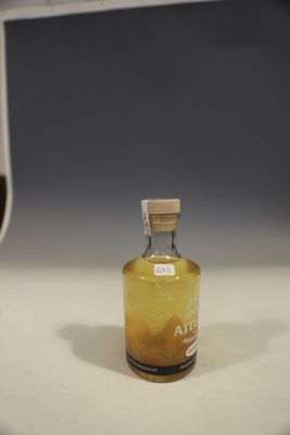 a small bottle of liquid sitting on a counter