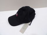 a black hat that is on a table with a tag