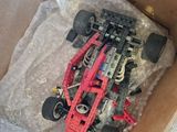 a box with a toy car in it sitting on the floor