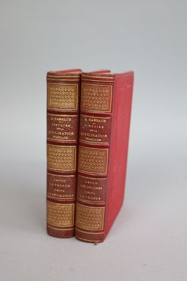 two red books sitting on top of each other on a table
