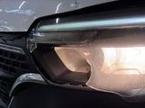 a close up of a car ' s headlight and front bumper