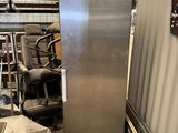 an image of a stainless steel refrigerator in a warehouse