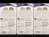 three packs of pokemon trading cards sitting on top of each other