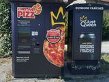 two vending machines sitting next to each other on the side of the road