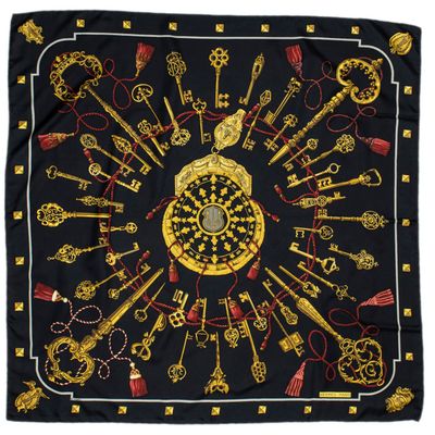 a black scarf with gold keys and keys on it