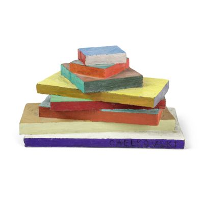 a stack of colorful blocks on a white surface