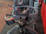 a gym room with a row of machines and a row of treads