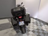a motorcycle that is parked in a room with a checkered floor