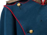 a close up of a blue uniform with gold buttons on a mannequin