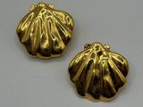 two gold plated shells on a white surface