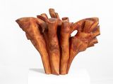 a sculpture of a bunch of wood sticks on a white pedestal