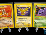 four different pokemon cards are displayed on a black background