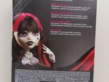 the back of a box with a doll in it sitting on a table