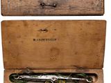 a wooden box with a pair of scissors inside of it