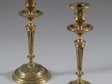 pair of antique brass candlesticks on a white background