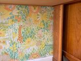 brightly colored wallpaper on the wall of a kitchen with a wooden cabinet