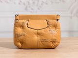 an image of a brown purse sitting on top of a wooden table