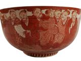 a red bowl with a picture of a group of people on it