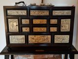 a black cabinet with a lot of drawers on top of it
