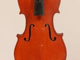an old violin with a bow hanging from it ' s back