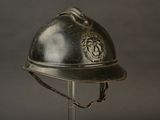 a silver helmet with a lion on it on a stand