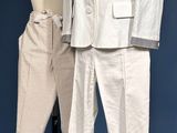 a white suit and pants on a mannequin stand