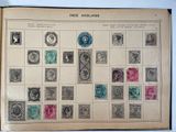 an old book with stamps on it sitting on top of a table