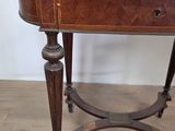 a small wooden table with a drawer on top of it