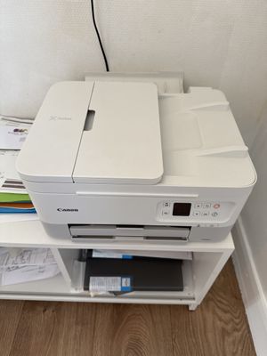 a printer that is sitting on top of a shelf