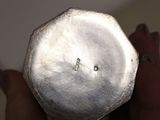 a person holding a silver object in their hand