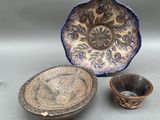 two bowls and a bowl sitting on top of a table next to each other