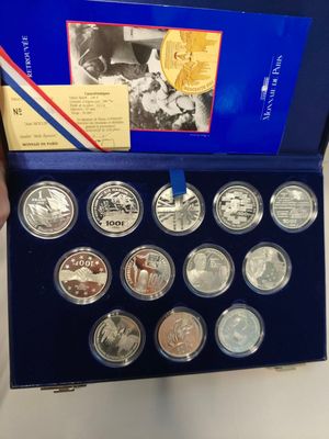 a person holding a box of silver coins with a picture of a man on it