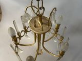 a gold chandelier hanging from the ceiling in a room