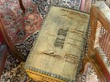 an old book sitting on the floor next to a chair