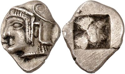 a silver coin with a face of a man and a head of a woman
