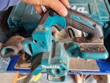 a person using a power tool to cut a piece of wood